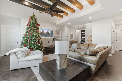 a living room with furniture potted plant and a window