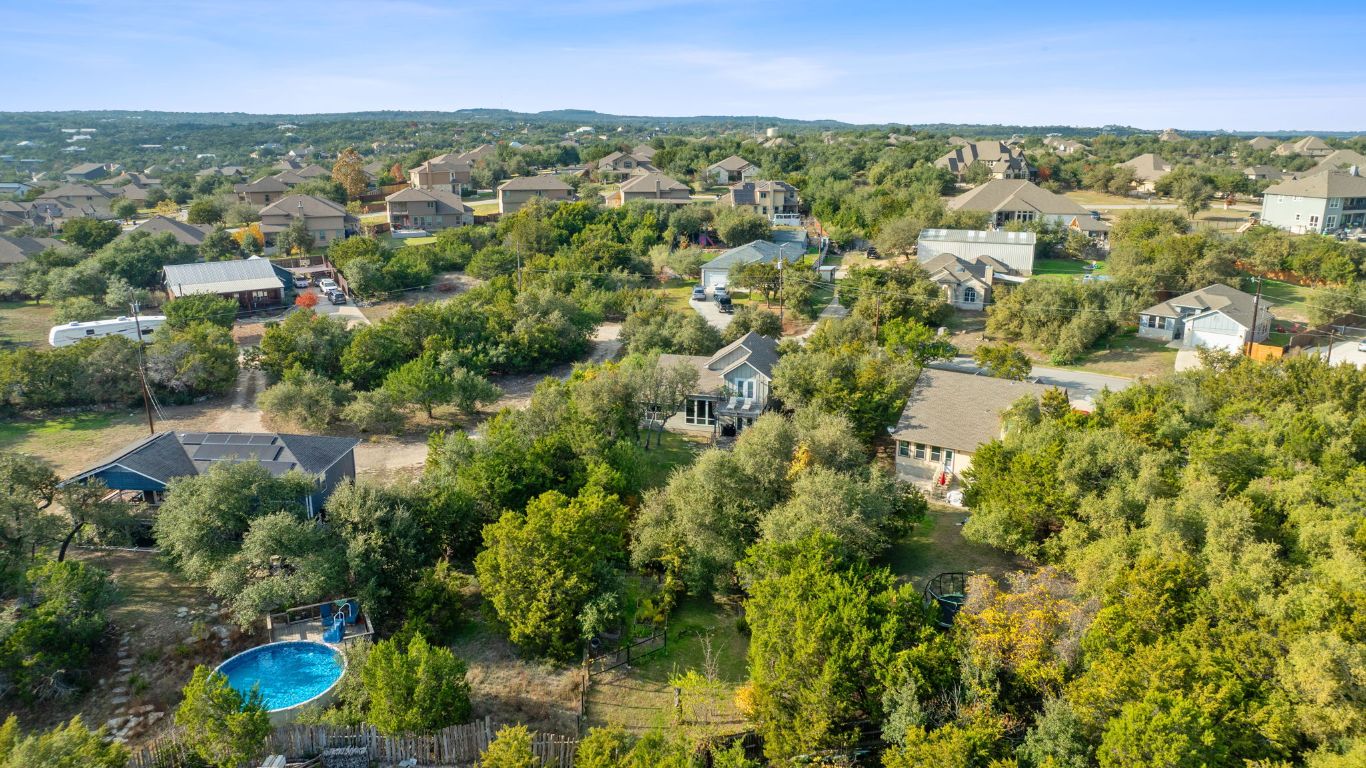 10012 Janet Loop Dripping Springs, TX 78620 - Photo 35 of 38 an aerial view of residential house with outdoor space and trees all around