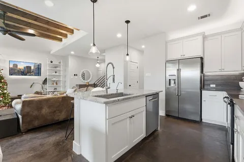a kitchen with kitchen island a counter top space appliances and a ceiling fan