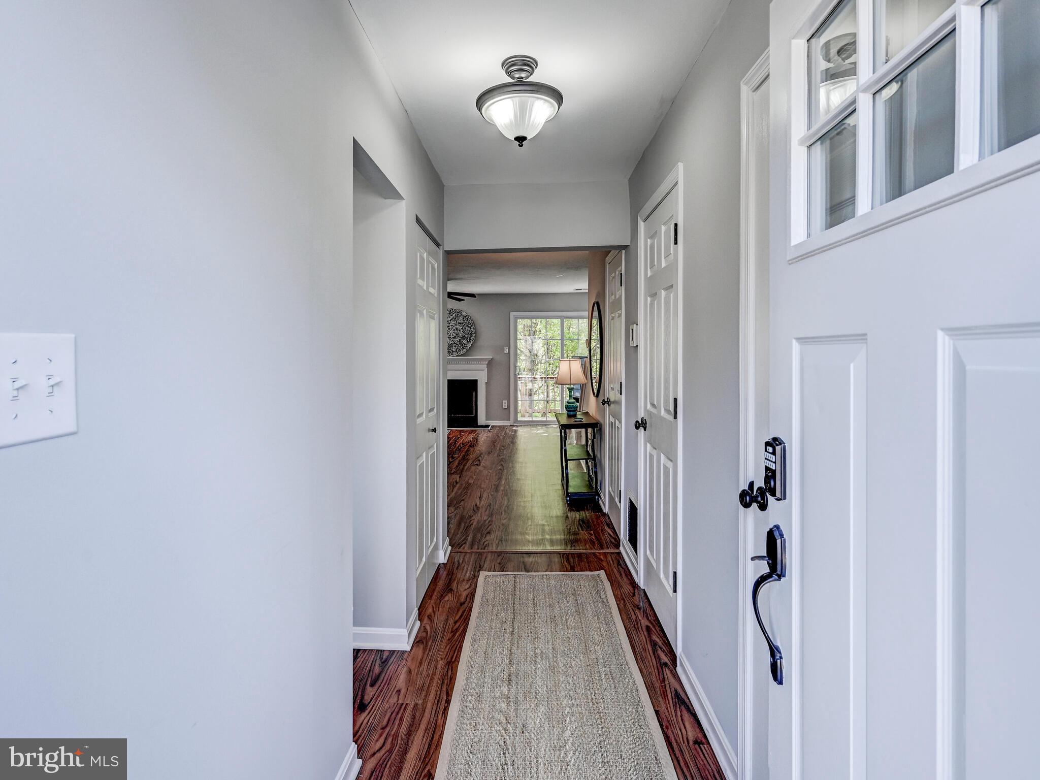 1679 Hart Court Crofton, MD 21114 - Photo 2 of 38 a view of a hallway with wooden floor and staircase