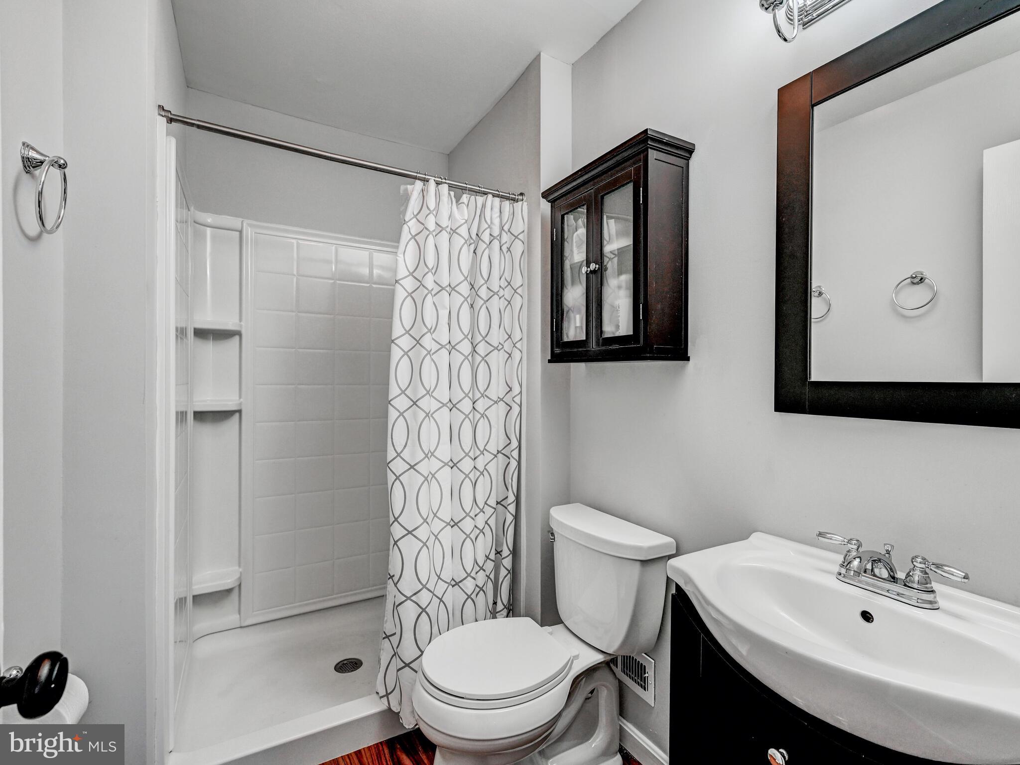 1679 Hart Court Crofton, MD 21114 - Photo 21 of 38 a bathroom with a sink a toilet and shower