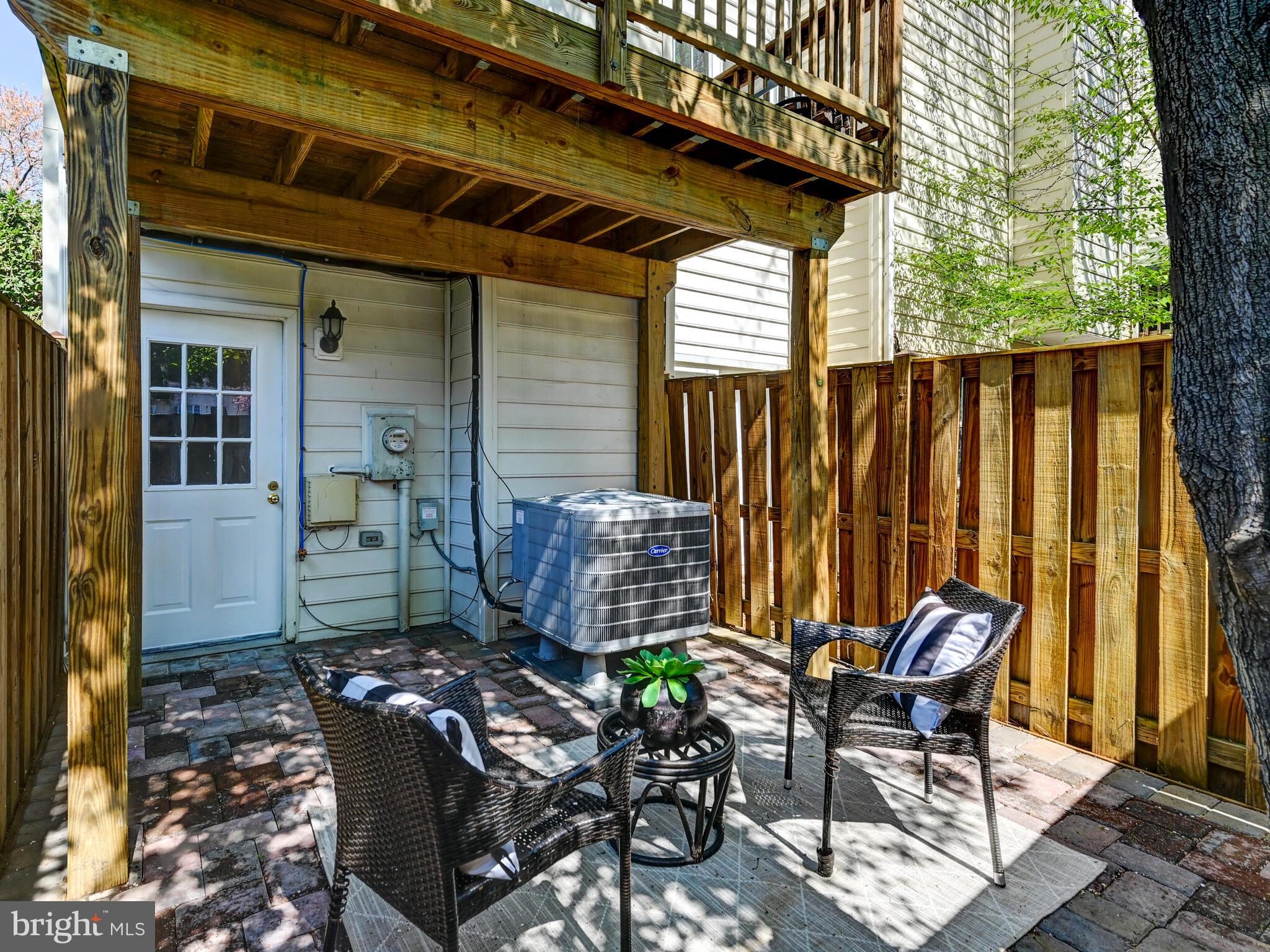 1679 Hart Court Crofton, MD 21114 - Photo 28 of 38 a view of a patio with table and chairs with wooden fence and plants