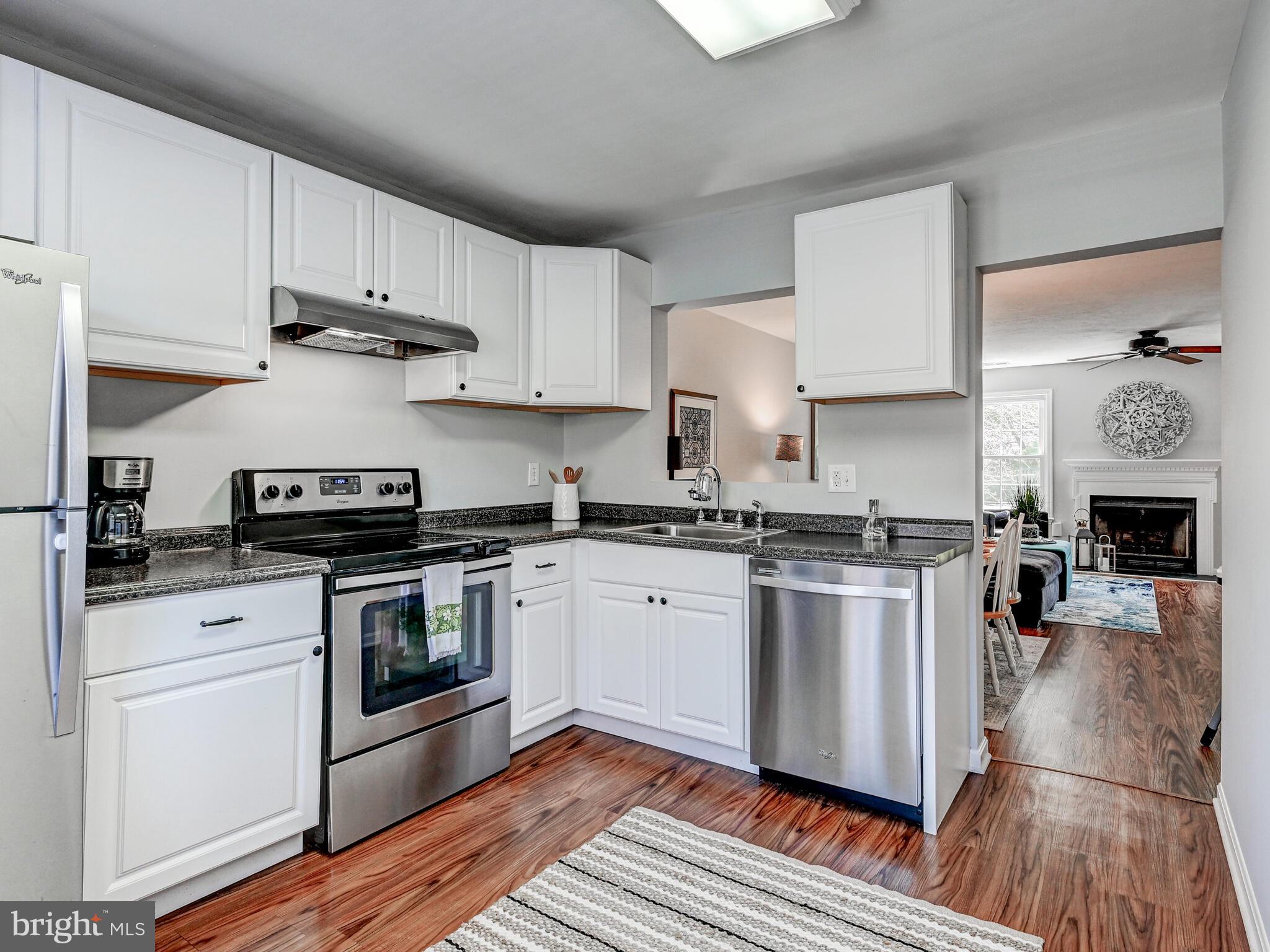 1679 Hart Court Crofton, MD 21114 - Photo 4 of 38 a kitchen with stainless steel appliances granite countertop a stove a sink and a white cabinets
