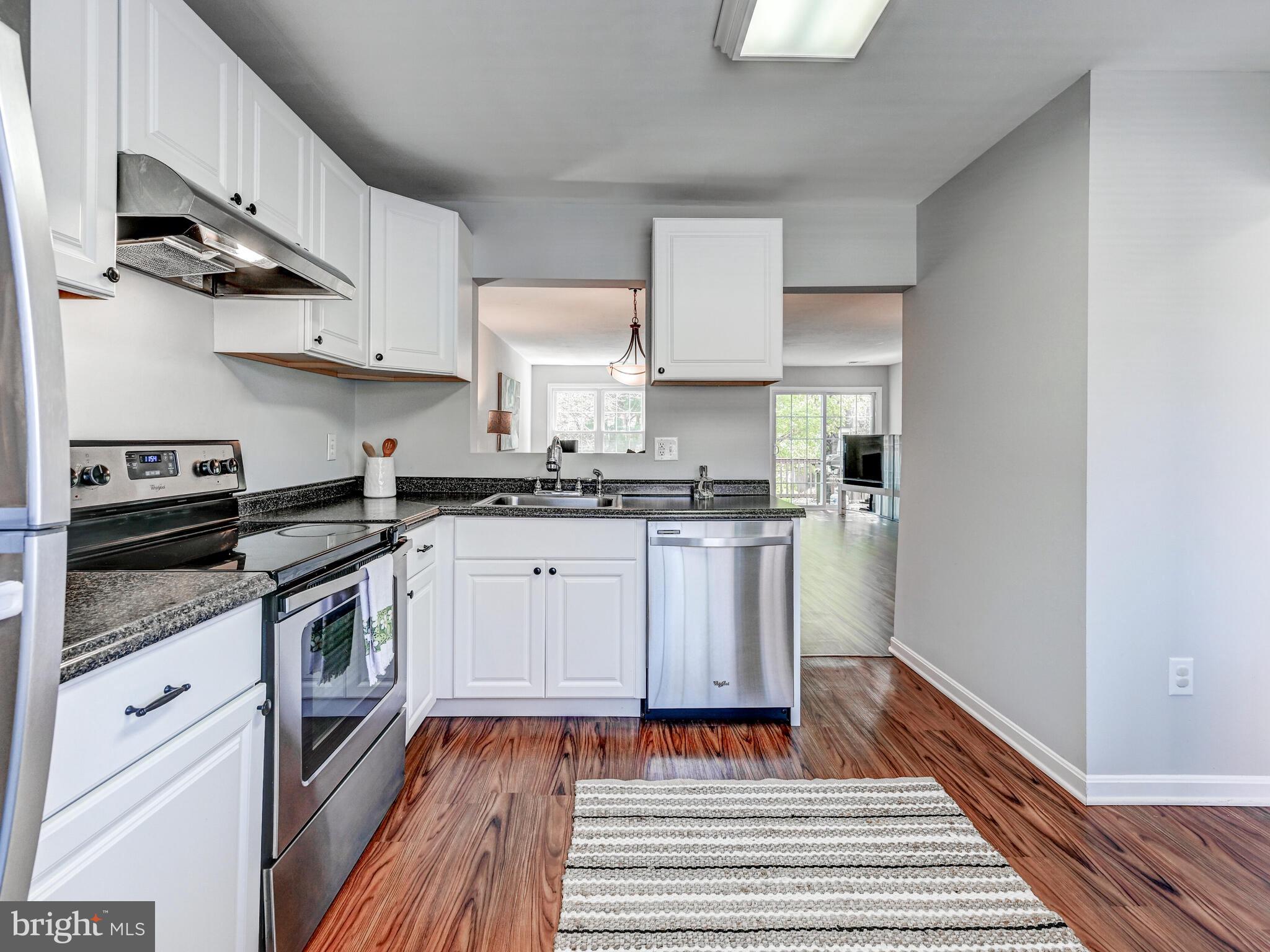 1679 Hart Court Crofton, MD 21114 - Photo 5 of 38 a kitchen with white cabinets and appliances