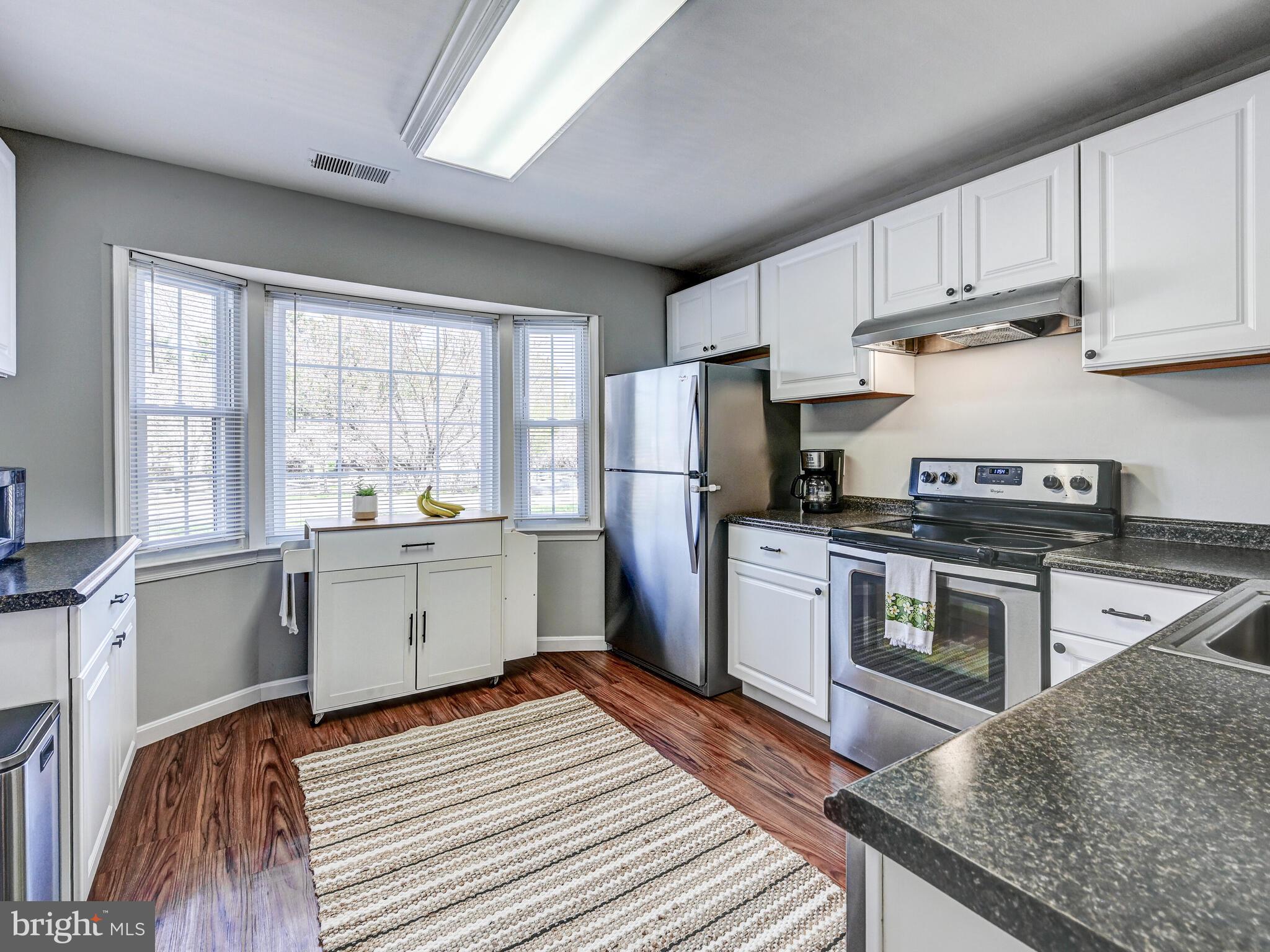 1679 Hart Court Crofton, MD 21114 - Photo 6 of 38 a kitchen with a refrigerator stove top oven and sink