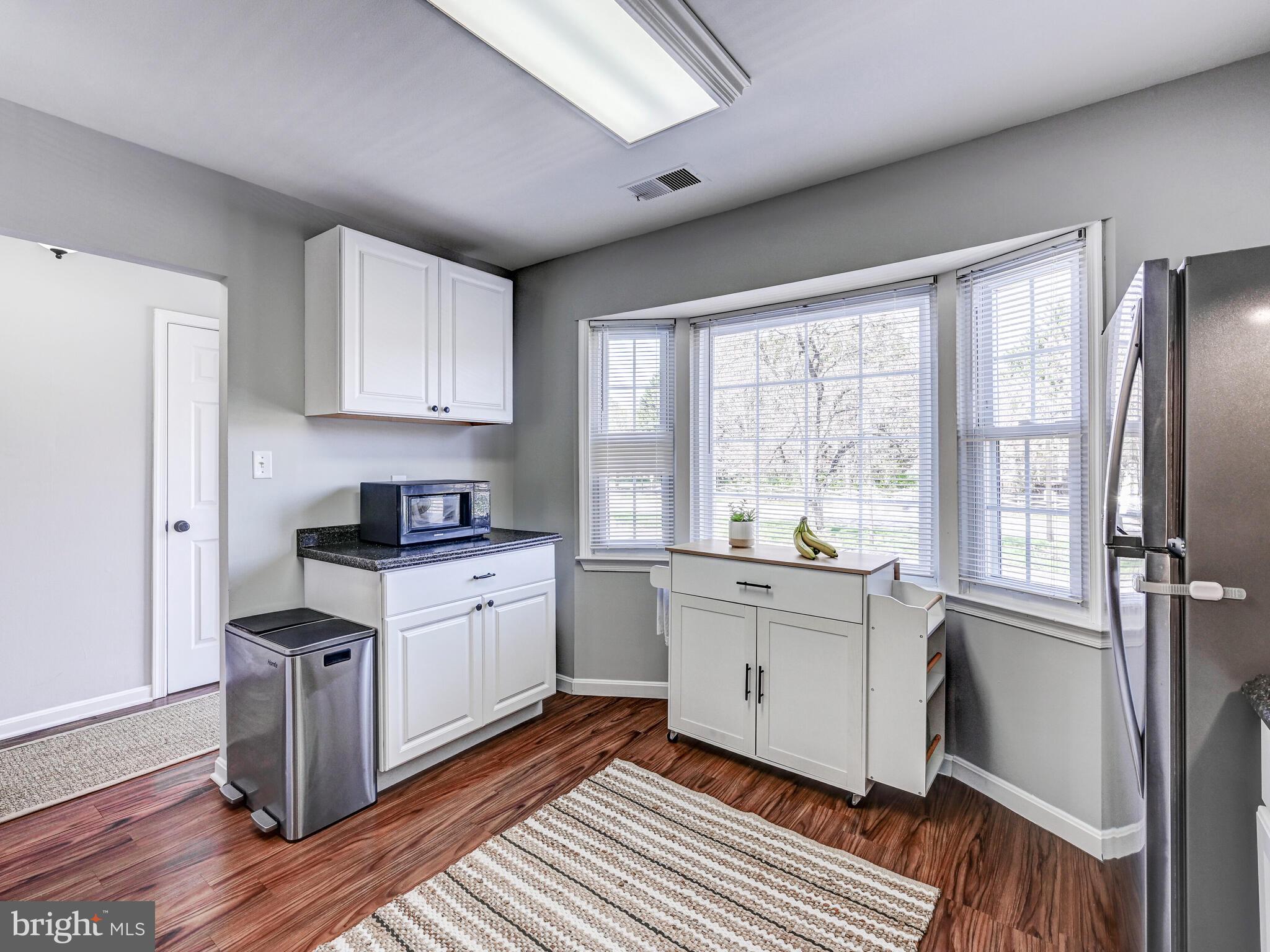 1679 Hart Court Crofton, MD 21114 - Photo 7 of 38 a kitchen with granite countertop a stove top oven sink and cabinets