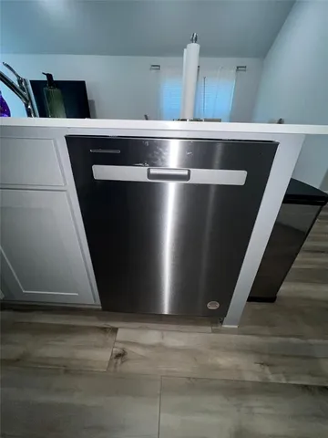 a kitchen with a cabinets and wooden floor