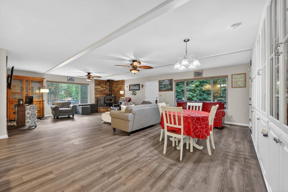 2026 Lily Valley Way West Point, CA 95255 - Photo 22 of 39 a living room with furniture a large window and wooden floor