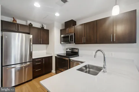 a kitchen with a refrigerator sink and microwave