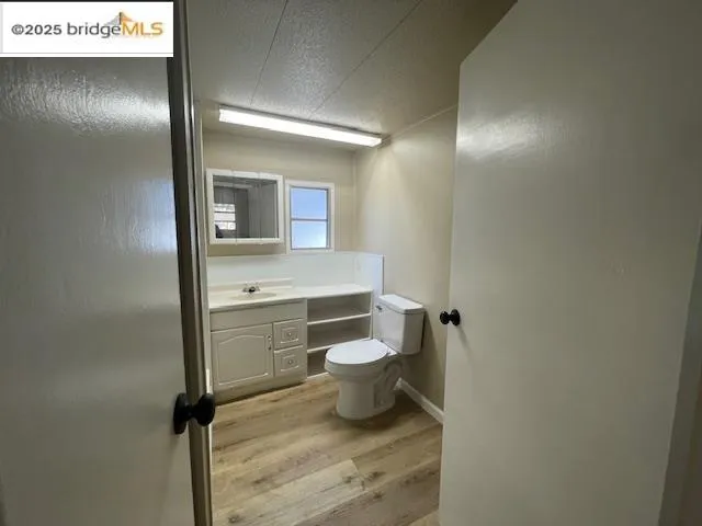 a bathroom with a toilet a sink and mirror