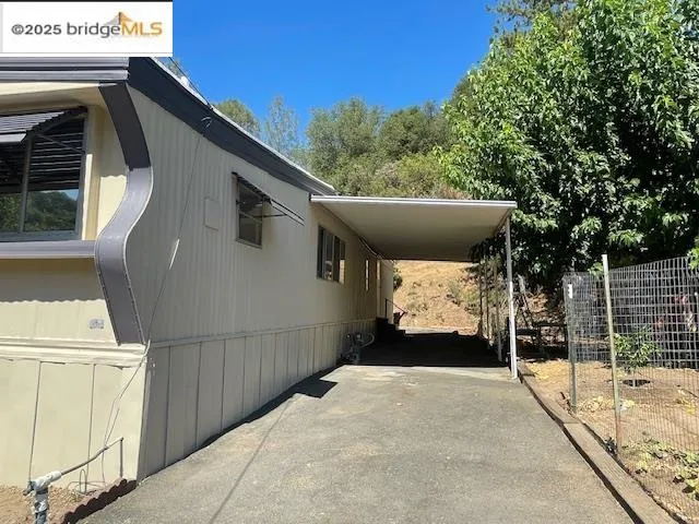 a side view of a house with a balcony