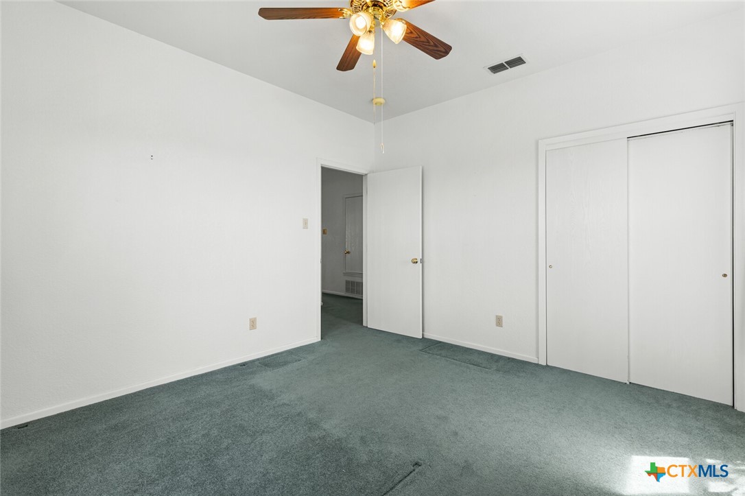 10514 Hunt Hill Road Rogers, TX 76569 - Photo 32 of 46 an empty room with a ceiling fan and a window