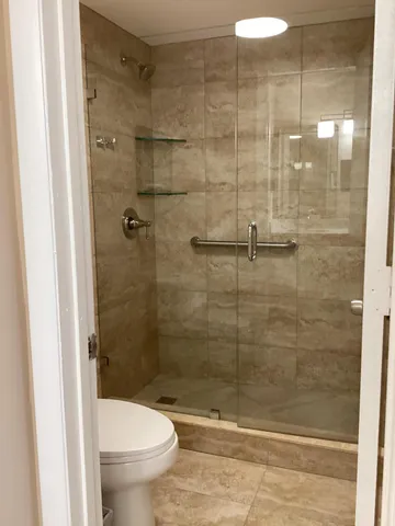 a bathroom with a shower and a toilet
