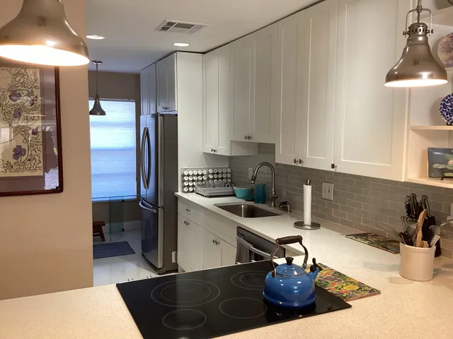 a kitchen with a sink and a stove top oven