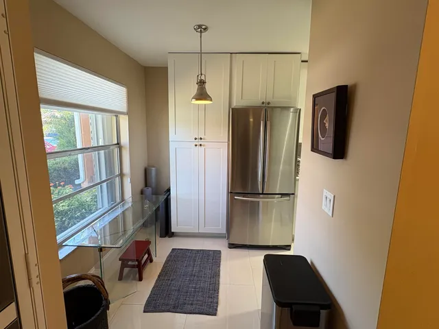 a kitchen with a refrigerator a stove and a window