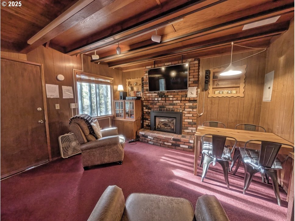 89255 Government Camp Loop Government Camp, OR 97028 - Photo 5 of 37 a living room with furniture a flat screen tv and a fireplace