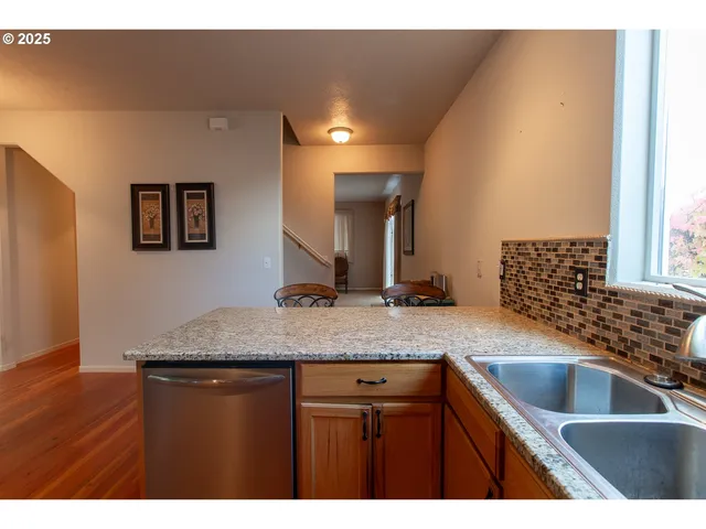 a kitchen with a sink a counter top space and cabinets