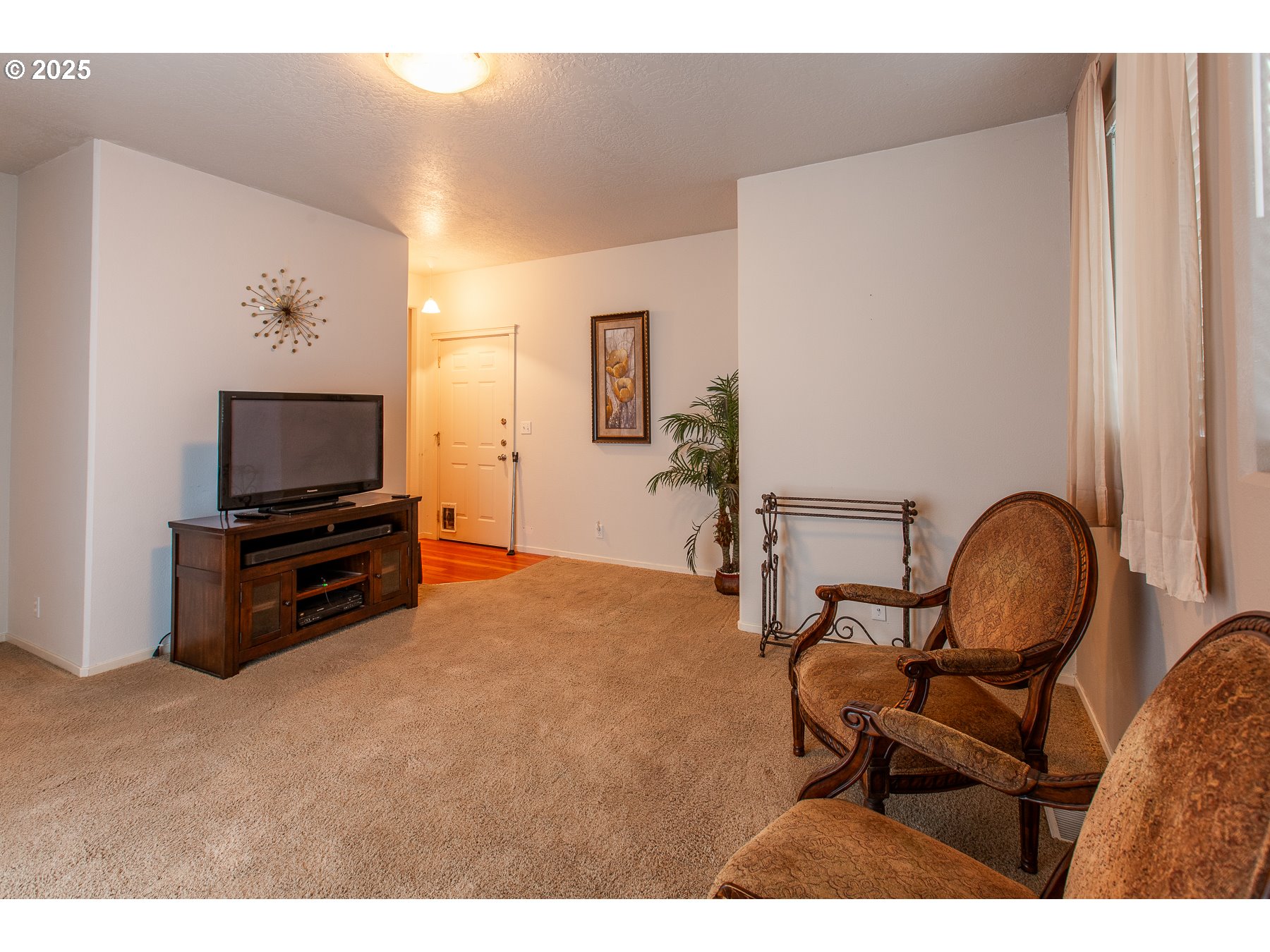 6964 Bluebelle Way Springfield, OR 97478 - Photo 13 of 35 a living room with furniture and a flat screen tv