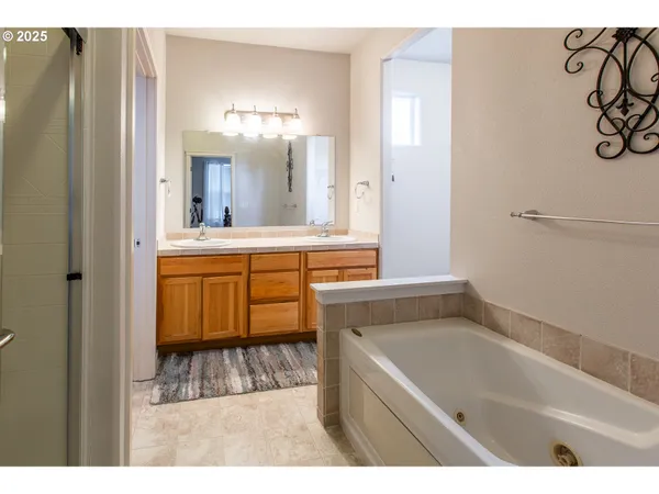 a bathroom with a tub sink and shower