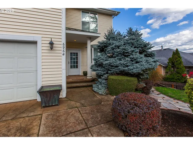 a backyard of a house with barbeque oven and a fire pit