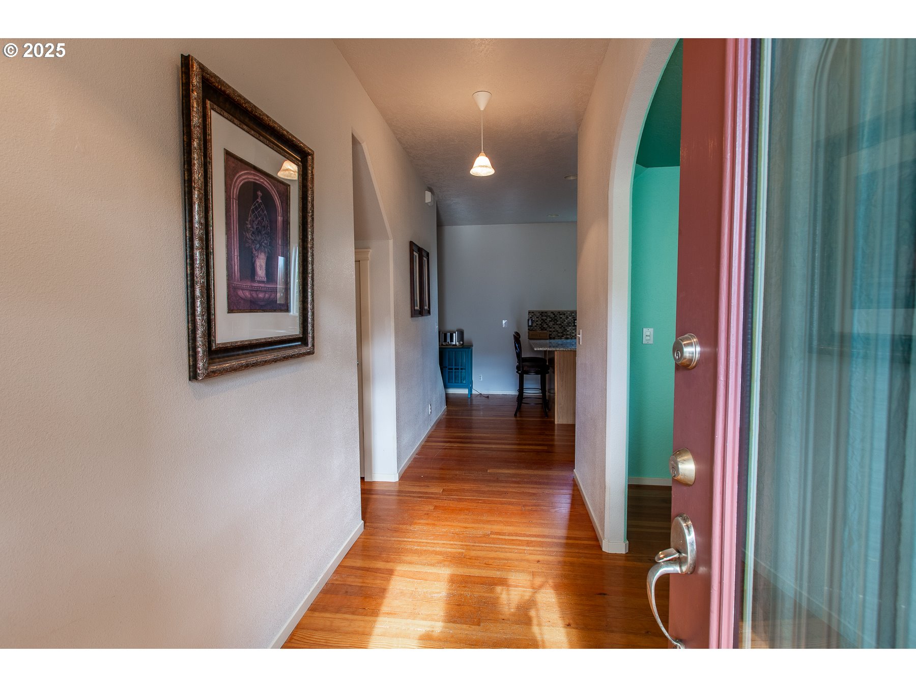 6964 Bluebelle Way Springfield, OR 97478 - Photo 3 of 35 a view of a hallway with wooden floor and stairs