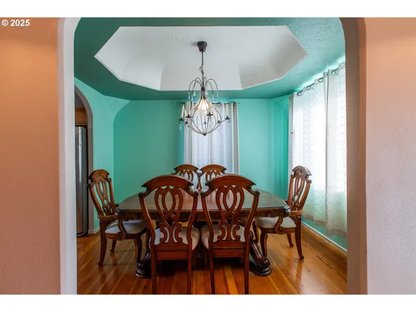 a view of a dining room with furniture and chandelier