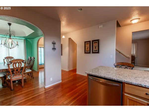 a kitchen with stainless steel appliances granite countertop a sink and a wooden cabinets