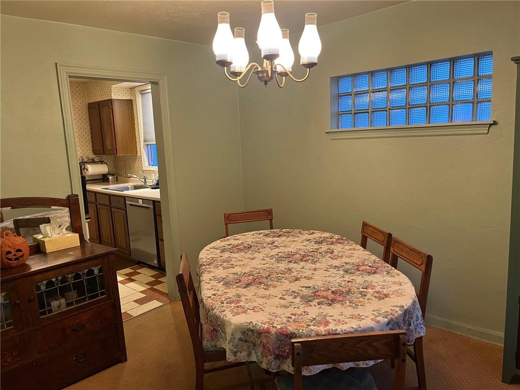 4914 McAnulty Road Pittsburgh, PA 15236 - Photo 14 of 17 a bedroom with a bed and a chandelier