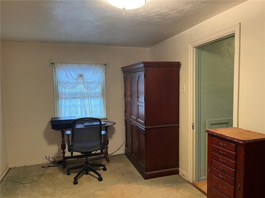 4914 McAnulty Road Pittsburgh, PA 15236 - Photo 8 of 17 a room with a refrigerator and a chair
