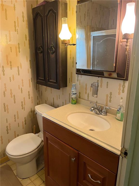 4914 McAnulty Road Pittsburgh, PA 15236 - Photo 9 of 17 a bathroom with a sink a toilet and mirror