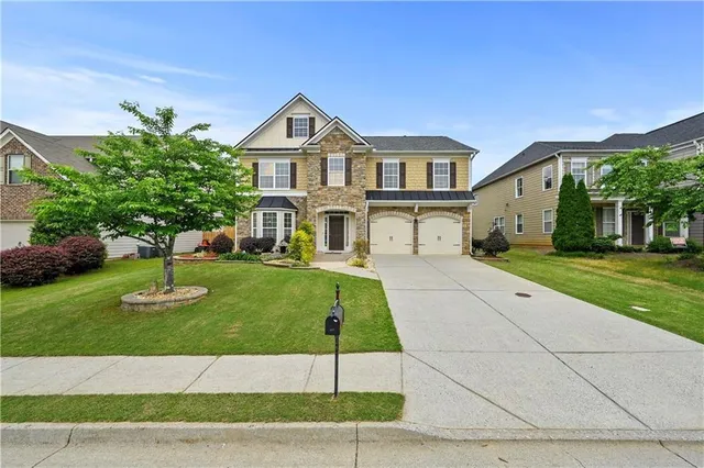 a front view of a house with a yard