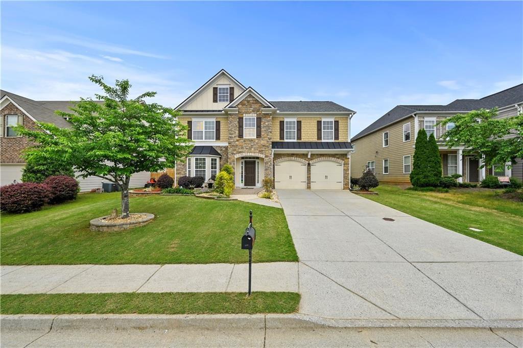 4195 Settlers Grove Road Cumming, GA 30028 - Photo 1 of 38 a front view of a house with a yard