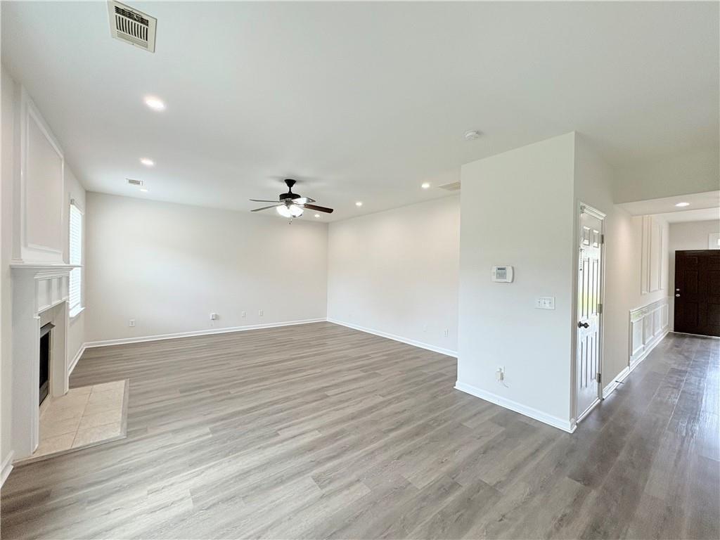 4195 Settlers Grove Road Cumming, GA 30028 - Photo 11 of 38 a view of empty room with wooden floor and fan
