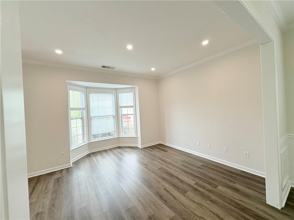 4195 Settlers Grove Road Cumming, GA 30028 - Photo 12 of 38 an empty room with wooden floor and windows