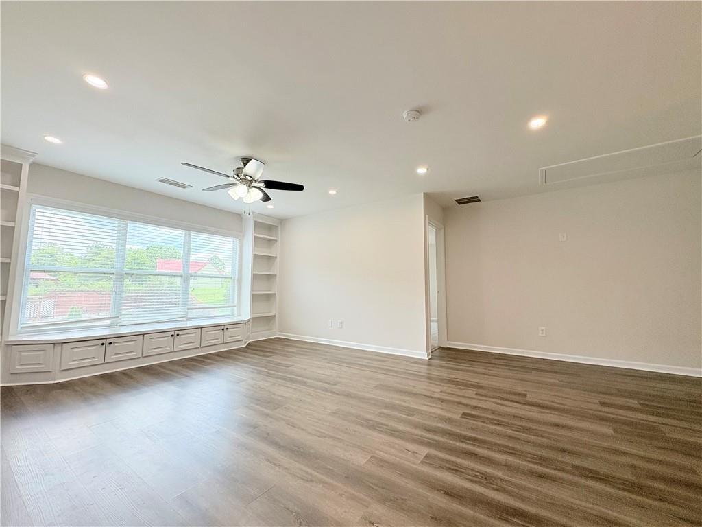 4195 Settlers Grove Road Cumming, GA 30028 - Photo 18 of 38 an empty room with wooden floor and windows