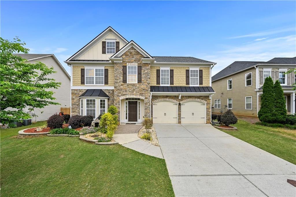 4195 Settlers Grove Road Cumming, GA 30028 - Photo 2 of 38 a front view of a house with a yard