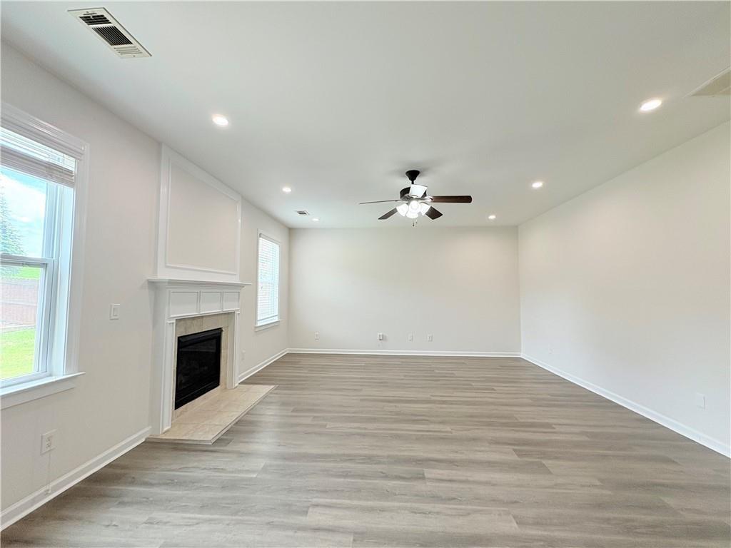 4195 Settlers Grove Road Cumming, GA 30028 - Photo 22 of 38 a view of empty room with wooden floor and fireplace