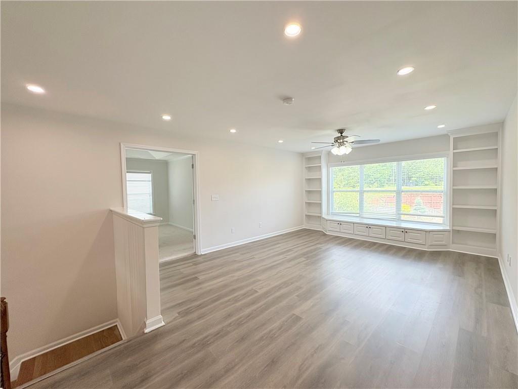 4195 Settlers Grove Road Cumming, GA 30028 - Photo 25 of 38 an empty room with wooden floor and windows