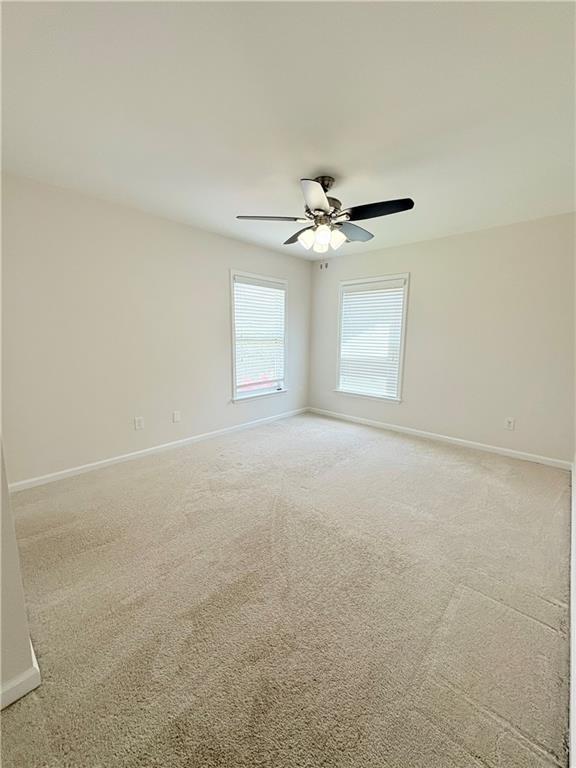 4195 Settlers Grove Road Cumming, GA 30028 - Photo 28 of 38 an empty room with windows and fan