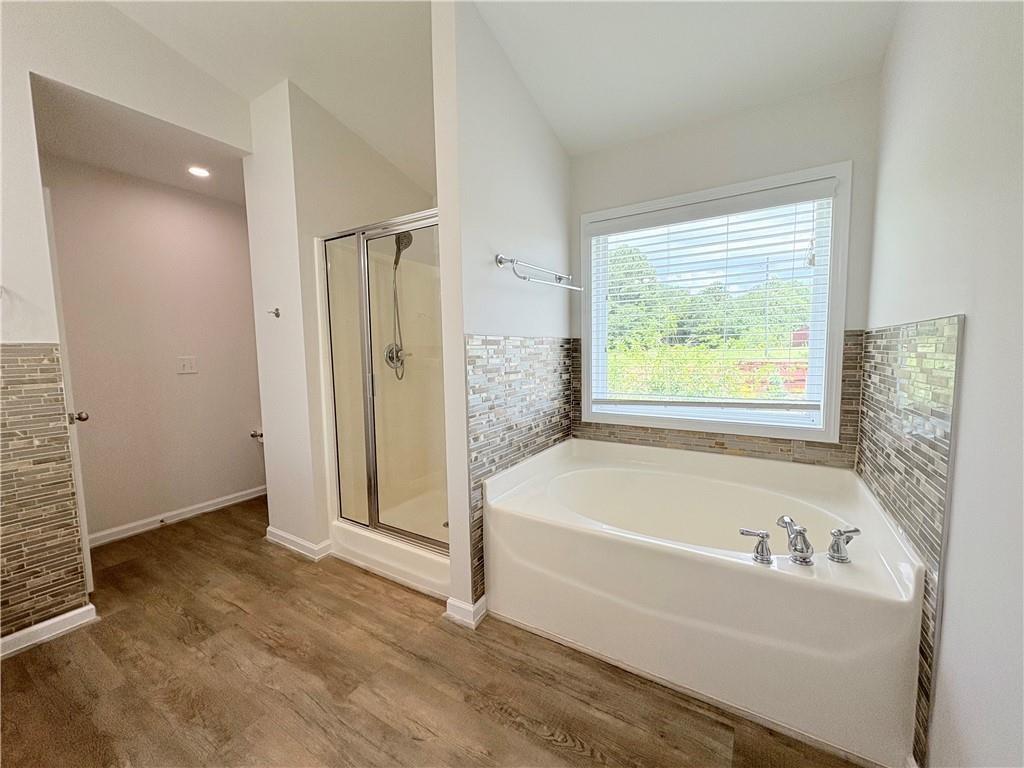 4195 Settlers Grove Road Cumming, GA 30028 - Photo 30 of 38 a bathroom with a bathtub and a shower