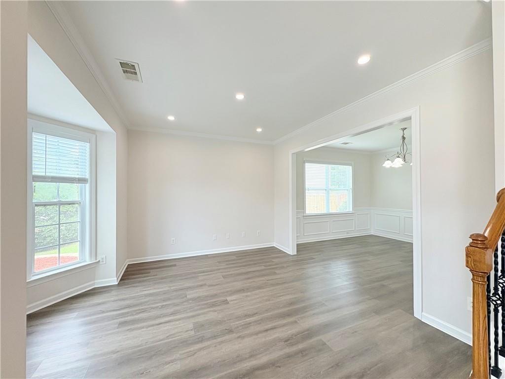 4195 Settlers Grove Road Cumming, GA 30028 - Photo 4 of 38 an empty room with wooden floor and windows