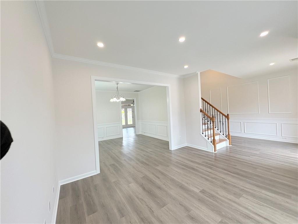 4195 Settlers Grove Road Cumming, GA 30028 - Photo 5 of 38 a view of an empty room with wooden floor and a window