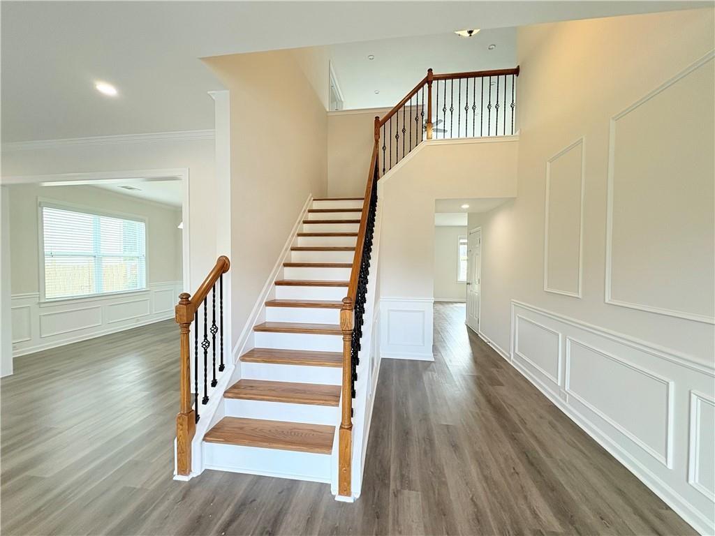 4195 Settlers Grove Road Cumming, GA 30028 - Photo 6 of 38 a view of entryway with wooden floor and stairs