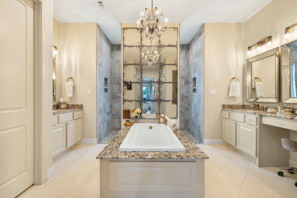 7650 Rolling Creek Road Burton, TX 77835 - Photo 12 of 22 a spacious bathroom with a granite countertop sink a large mirror and a shower
