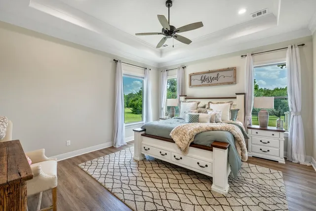 a spacious bathroom with a granite countertop sink a large mirror and a shower
