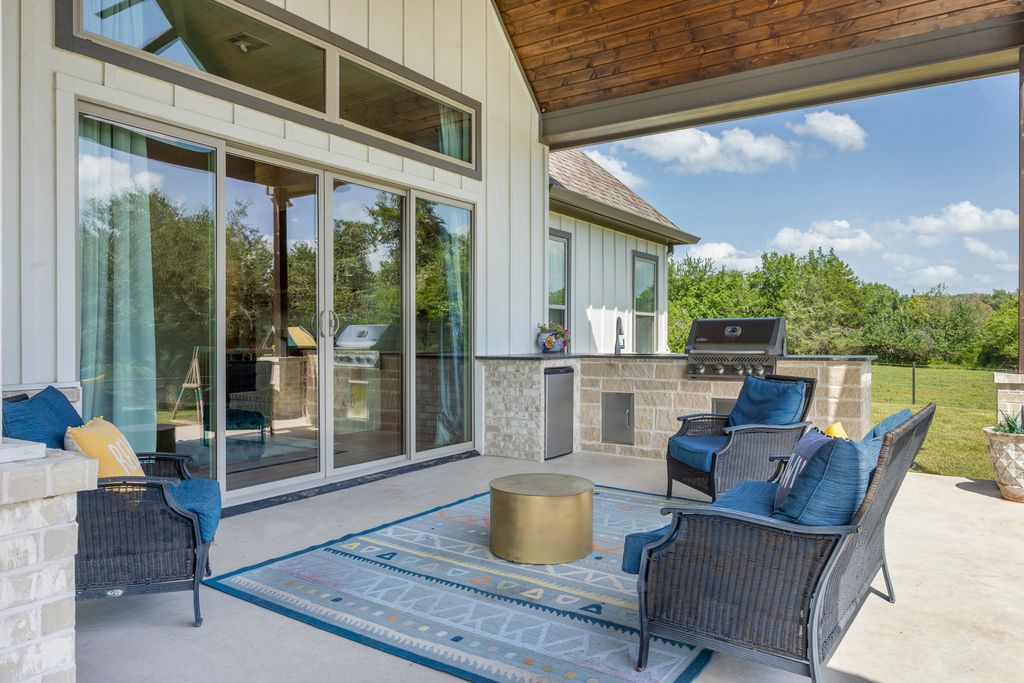 7650 Rolling Creek Road Burton, TX 77835 - Photo 19 of 22 a dining room with furniture and a floor to ceiling window