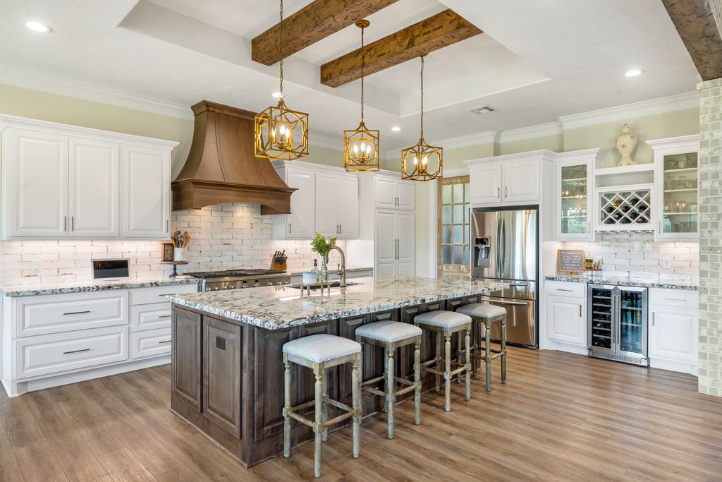 7650 Rolling Creek Road Burton, TX 77835 - Photo 6 of 22 a kitchen with kitchen island granite countertop a sink a center island and stainless steel appliances