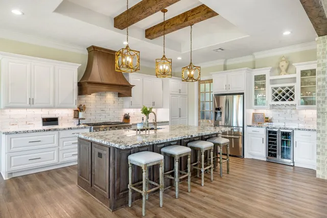 a kitchen with stainless steel appliances granite countertop a sink and stove
