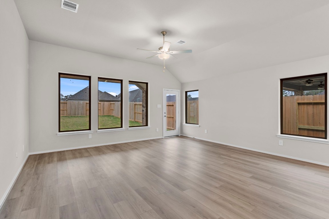 9526 Sierra Crest Lane Porter, TX 77365 - Photo 12 of 39 a view of an empty room with a window and wooden floor