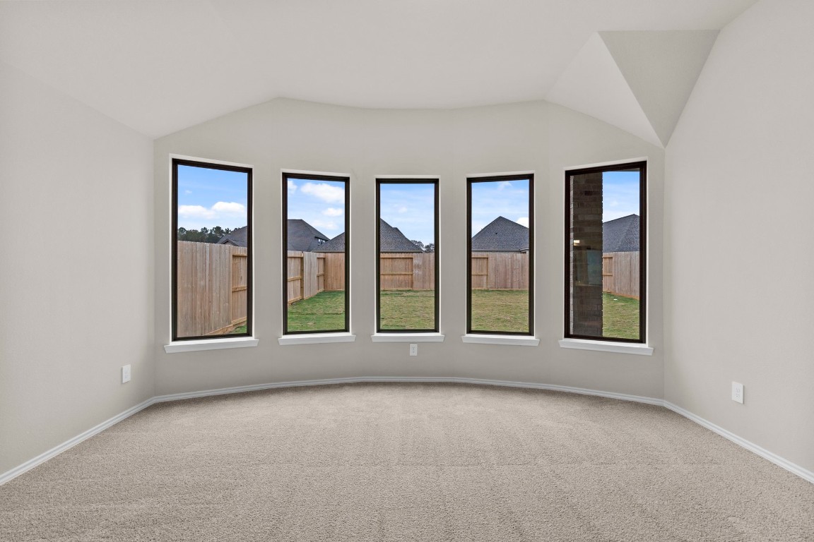 9526 Sierra Crest Lane Porter, TX 77365 - Photo 16 of 39 an empty room with large windows and outdoor view